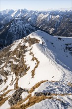 Ski tourers at the summit of Schafreuter, view of snow-covered mountain panorama, Karwendel, Tyrol,