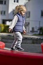 Little girl, 2 years, blond, balancing, playing, playground, Stuttgart, Baden-Württemberg, Germany,