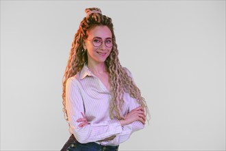 Young woman with dreadlocks crossed hands on chest