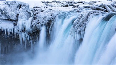 Godafoss waterfall, icy and snowy rock face, Northern Iceland Eyestra, Iceland, Europe