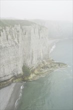 Chalk cliffs at Etretat in the mist, Côte d'Albâtre, Upper Normandy, France, Europe