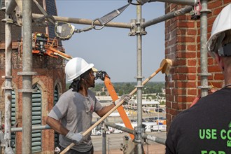 Detroit, Michigan, Anthony Powell cleans the bell towers of the Basilica of Ste. Anne de Detroit.