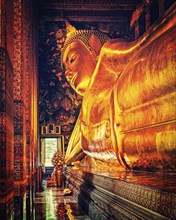 Vintage retro effect filtered hipster style image of reclining Buddha gold statue. Wat Pho,