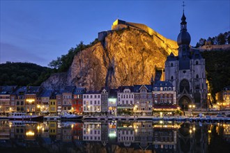 Night view of Dinant town, Collegiate Church of Notre Dame de Dinant over River Meuse and Pont