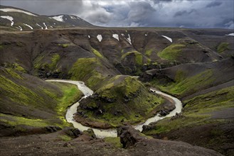 River bend, foot Asgardsa, volcanic landscape with black rocks and green moss, dramatic cloudy sky,