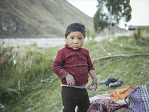 Child of a miner in an open pit kaolin mine, Pachacayo, Peru, South America