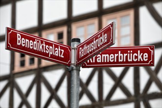 Red street signs in front of half-timbered houses in the old town, Erfurt, Thuringia, Germany,