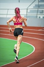 Athlete running at high speed on a track in the stadium, Glaspalast, Sindelfingen