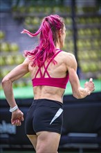 Athlete with striking red hair colour runs purposefully in the stadium, Glaspalast, Sindelfingen