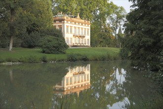 Classicist castle and reflection in the lake in Schönbusch Park, Aschaffenburg, Lower Franconia,