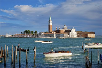 VENICE, ITALY, JUNE 27, 2018: Taxi boats in the lagoon of Venice by Saint Mark (San Marco) square