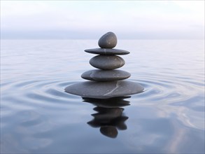 Zen stones in water with reflection, peace balance meditation relaxation concept