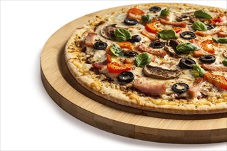 Ham pizza with (capsicum), mushrooms, olives and basil leaves isolated on white