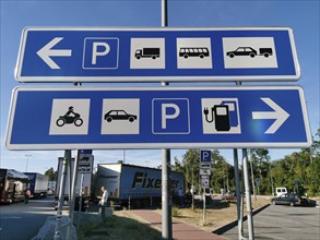 Traffic sign, sorting sign on a motorway car park for separate parking spaces for cars and trucks,