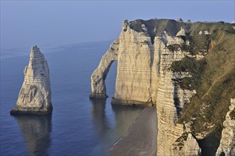 L'Aiguille and the Porte D'Aval, a natural arch in the chalk cliffs at Etretat, Côte d'Albâtre,