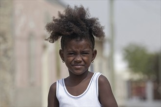 Close up portrait of Creole girl with frizzy hair on the island Boa Vista, Cape Verde, Cabo Verde,