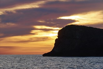 Sunset, dusk, orange sky, black rock, grey clouds, Marettimo, Egadi Islands, Sicily, Italy, Europe