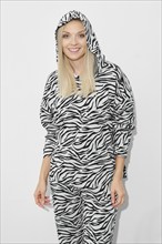 Beautiful woman in patterned zebra fleece suit with hood