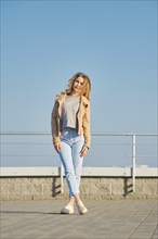 Young woman in casual clothes posing on the street