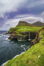 Gasadalur waterfall into the ocean, Vagar, Faroe islands, Denmark, Europe