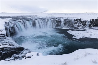 Godafoss waterfall, icy and snowy rock face, snowy landscape, Northern Iceland Eyestra, Iceland,