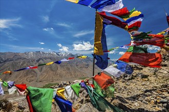 Buddhist prayer flags lungta with Om mani padme hum mantra written on them in Spiti Valley in