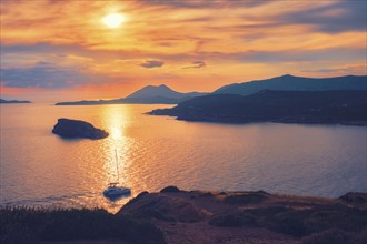 Aegean Sea with Greek islands view on sunset with yacht in sea. Cape Sounion, Greece, Europe