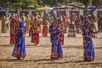 PUSHKAR, INDIA, NOVEMBER 21, 2012: Unidentified Rajasthani girls in traditional outfits dancing at