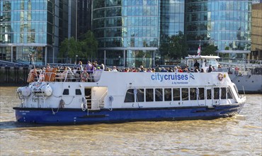 Sightseeing boat tour on River Thames, City Cruises by Hornblower, London, England, UK