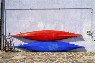 Two sea kayaks at a blue house, colourful houses on the island of Burano, Venice, Veneto, Italy,