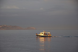 Morning light, cloudy sky, fishing boat, harbour, Heraklion, capital, island of Crete, Greece,