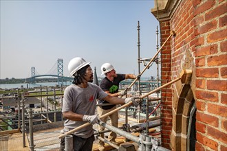 Detroit, Michigan, Anthony Powell (left) and Kevin Driscoll clean and repair the bell towers of the