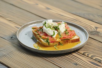 Benedict sandwich with salmon and poached egg on a plate