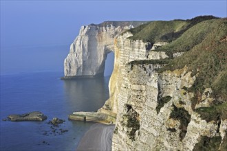 La Manneporte at sunset, a natural arch in the chalk cliffs at Etretat, Côte d'Albâtre, Upper