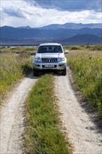 A Toyota Landcruiser off-road vehicle on a dirt track, Yssykköl, Kyrgyzstan, Asia