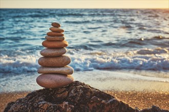 Concept of balance and harmony. Cairn stack of stones pebbles cairn on the beach coast of the sea