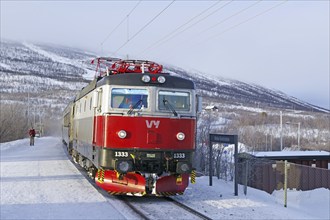 A passenger train in a wintry landscape in Abisko, National Park, Archipelago, Lapland, Sweden,