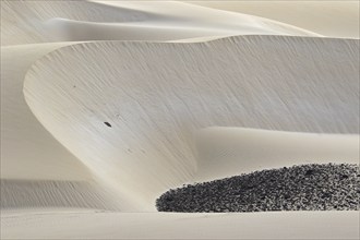 Dunes formed by blown in Sahara desert sand and volcanic rocks in the Deserto de Viana desert on