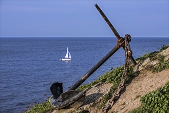 Old ship's anchor along the Brittany coast, France, Europe