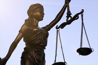 Close-up of a Justitia in front of a blue sky