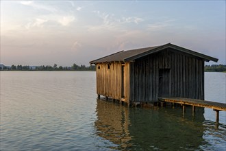 Boathouse with wooden jetty, sunset at Lake Kochel near Kochel am See, Bavarian Alpine foothills,