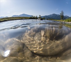 Underwater photograph of a river in front of mountains in sunlight, summer, Loisach, Schlehdorf,