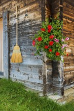 Lovingly decorated mountain hut, wooden hut, alpine hut, picturesque, flowers, broomTourism,