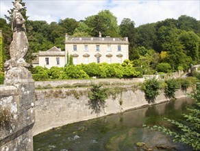 Statue of Britannia on the fifteenth century bridge over the River Frome, Iford Manor, near