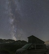 Nocturnal starry sky over the Furka Pass in the Swiss Alps. The night photograph shows the stars of