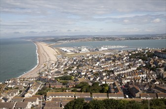 Chesil beach tombolo with housing in Chiswell in the foreground, Isle of Portland, Dorset, England,