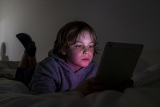 A boy plays computer games on a tablet PC