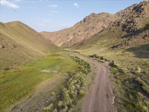 Gravel road through a mountain valley, Naryn region, Kyrgyzstan, Asia