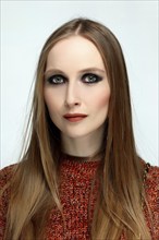 Close up portrait of a girl with provocative evening make up and long hair