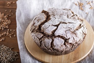 Yeast free homemade bread with whole rye and wheat grains on rustic wooden background. close up